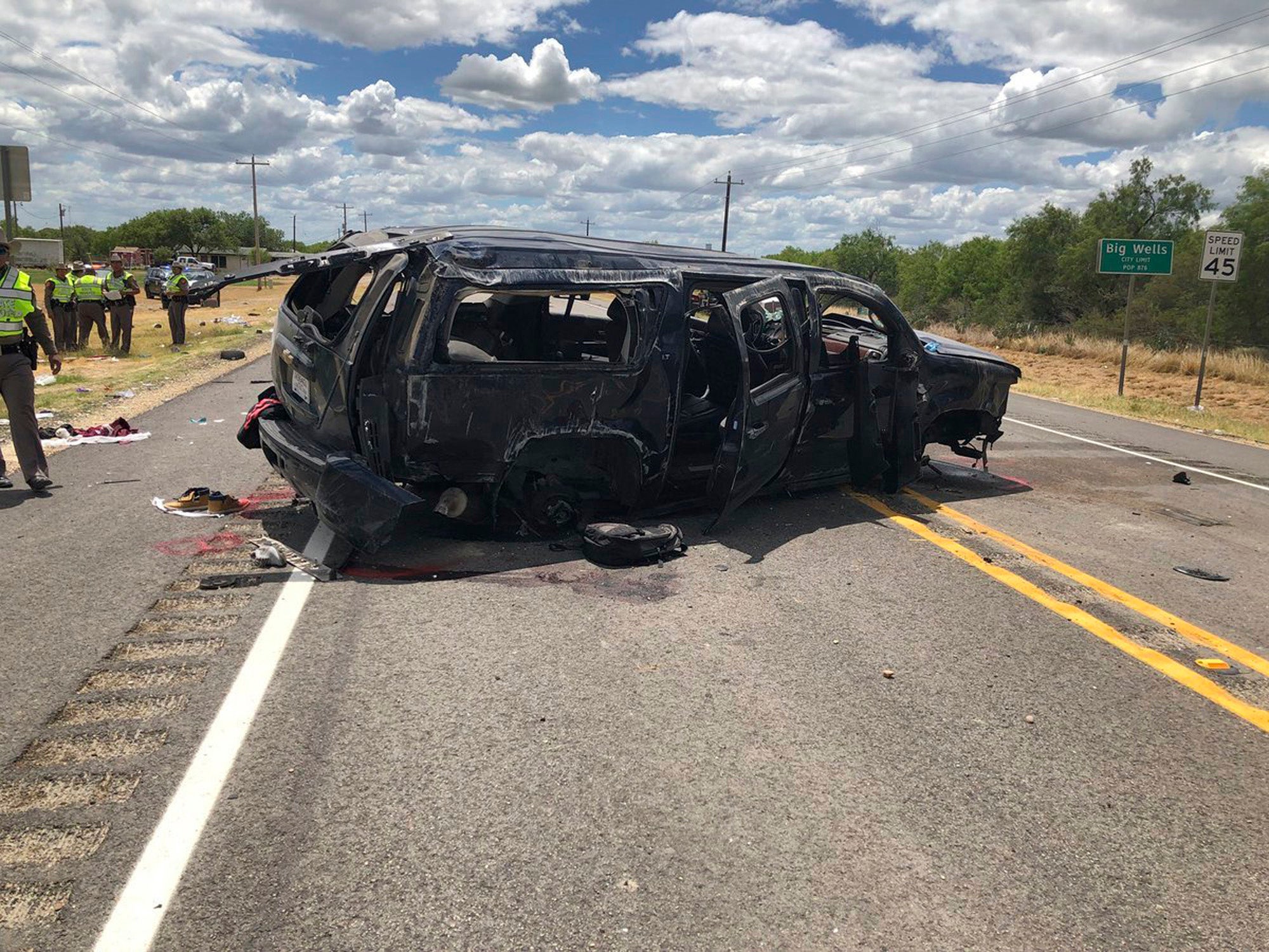 Damaged SUV is seen on Texas Highway 85 in Big Wells, Texas, after crashing while carrying more than a dozen people fleeing from Border Patrol agents, Sunday, June 17, 2018