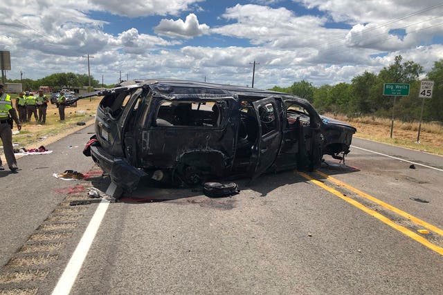 Damaged SUV is seen on Texas Highway 85 in Big Wells, Texas, after crashing while carrying more than a dozen people fleeing from Border Patrol agents, Sunday, June 17, 2018