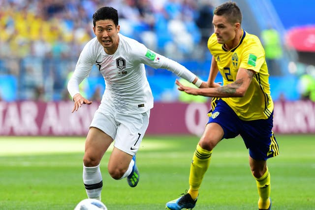 Son Heung-min fends off Mikael Lustig during South Korea's encounter with Sweden