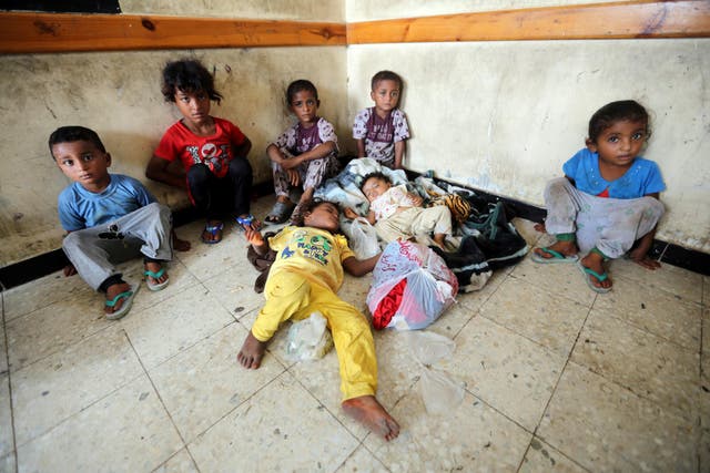 Children sit in a classroom of a school to which they have been evacuated from a village near Hodeidah airport amid fighting between government forces and Houthi fighters in Hodeidah, on 17 June 2018