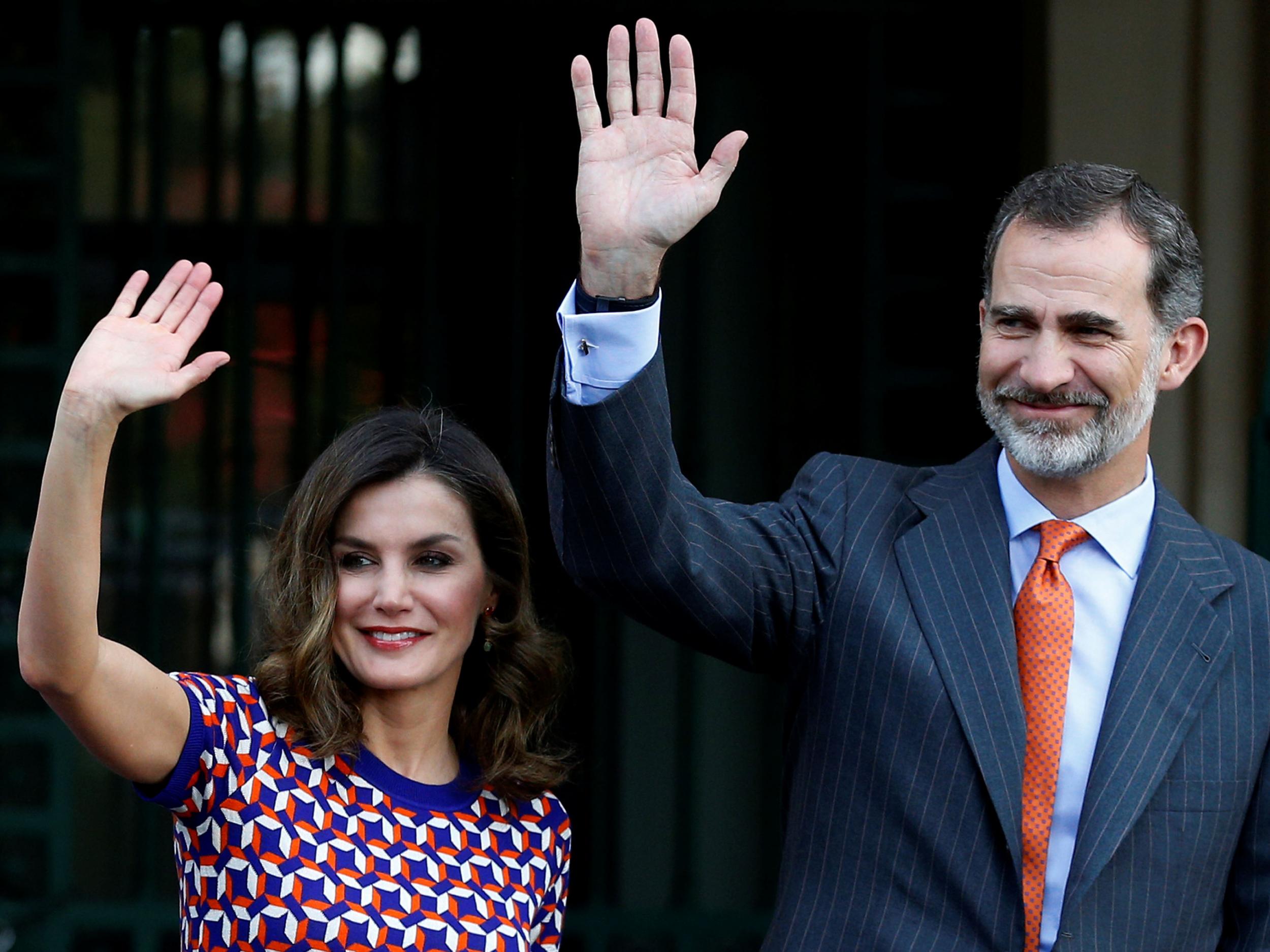 Spain's King Felipe VI and Queen Letizia wave as they arrive at the Cabildo in New Orleans, Louisiana, on 15 June 2018