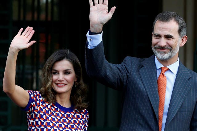 Spain's King Felipe VI and Queen Letizia wave as they arrive at the Cabildo in New Orleans, Louisiana, on 15 June 2018