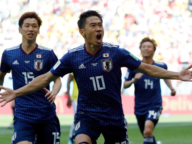 Japan's midfielder Shinji Kagawa celebrates with teammates after scoring a penalty