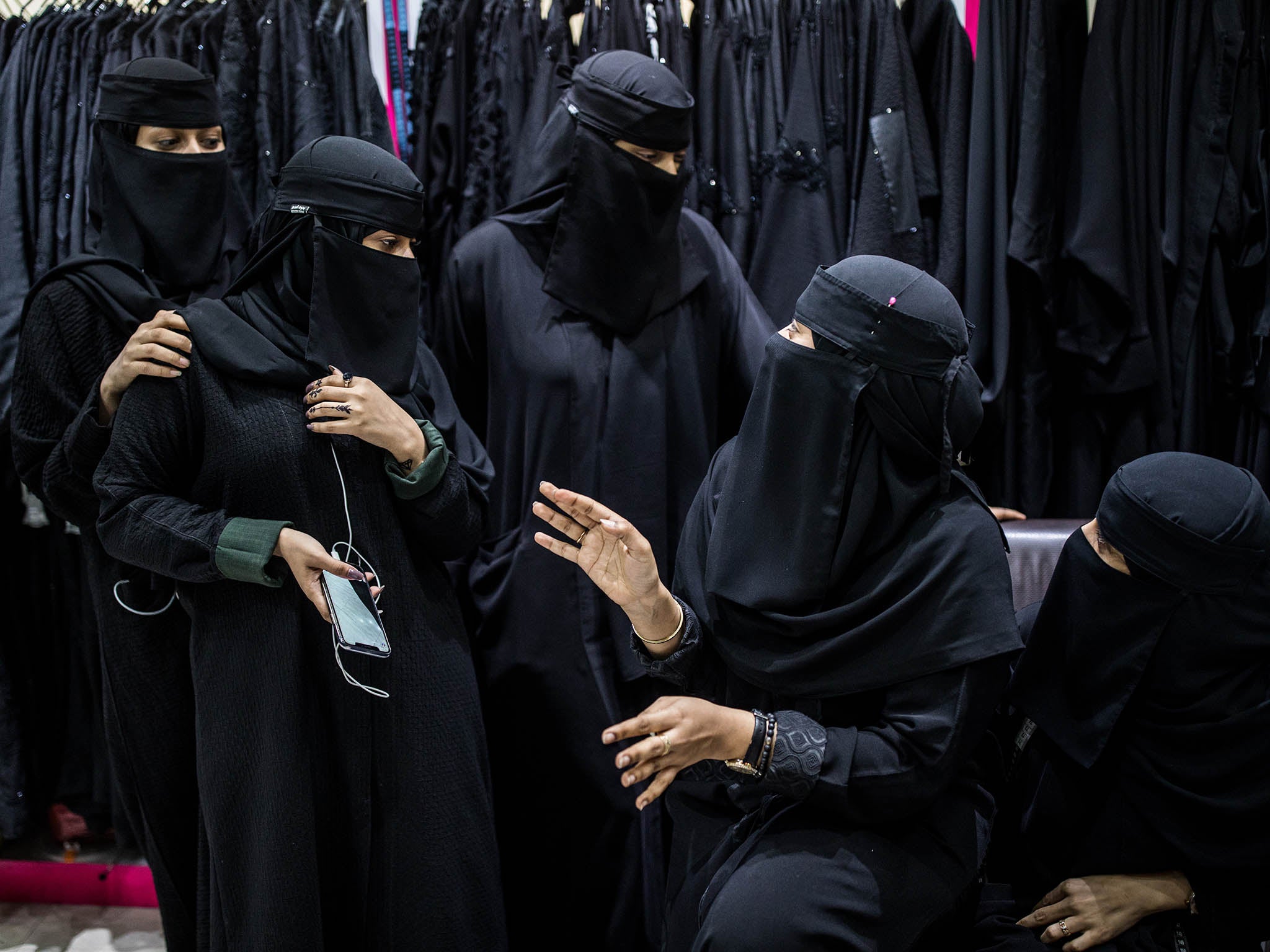 Employees take a break at an abaya shop in Riyadh