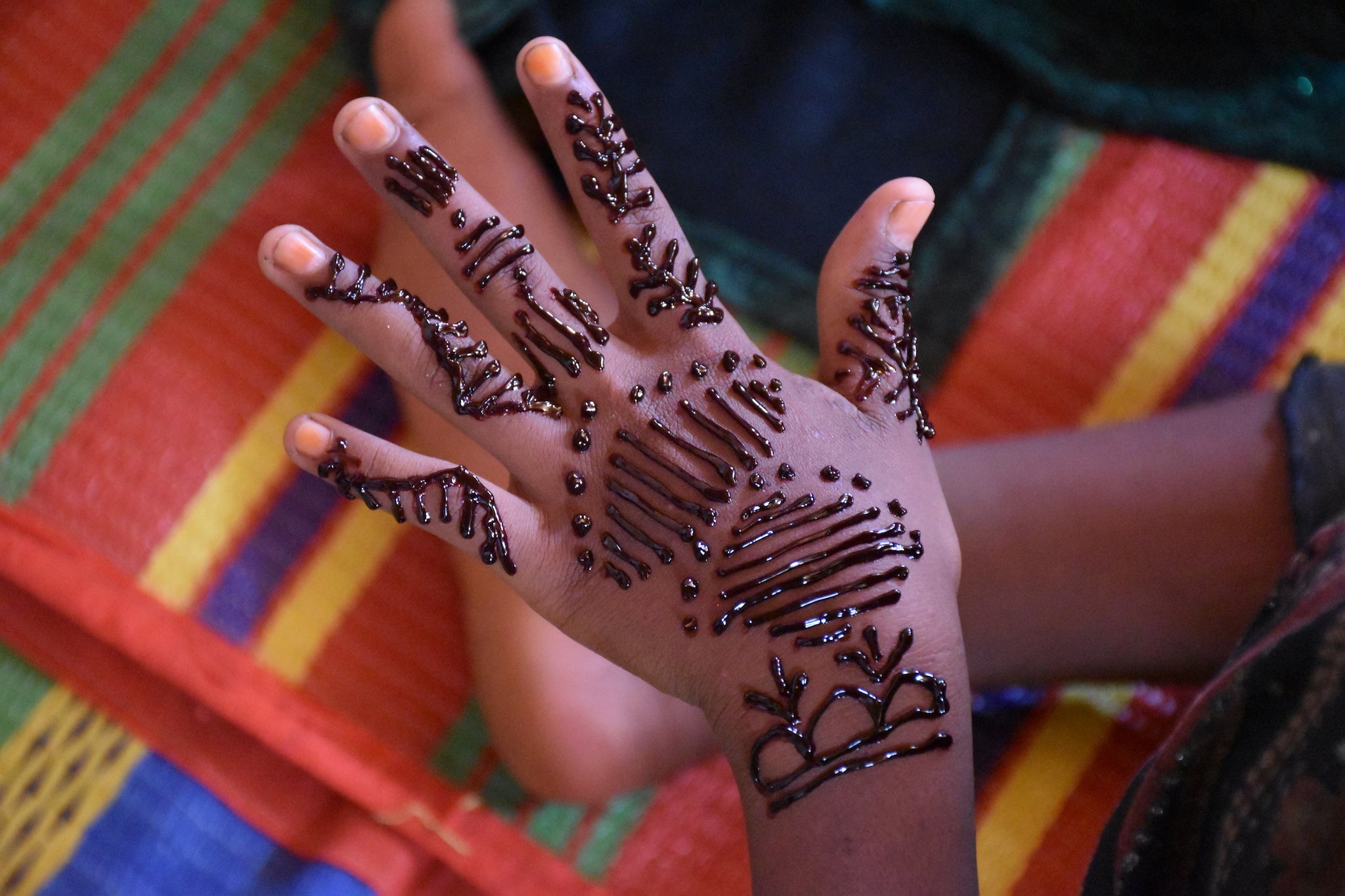 Girls take part in a henna activity in one of IRC's women-only centres