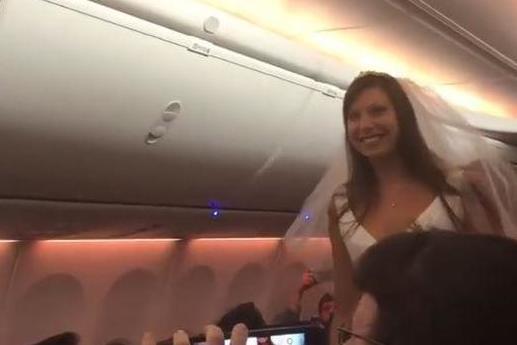 The bride-to-be walks down the aisle on the Southwest flight from Las Vegas to Baltimore