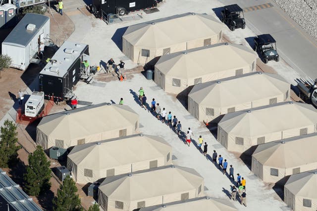 Immigrant children now housed in a tent encampment under the new 'zero tolerance' policy by the Trump administration are shown walking in single file at the facility near the Mexican border in Tornillo, Texas