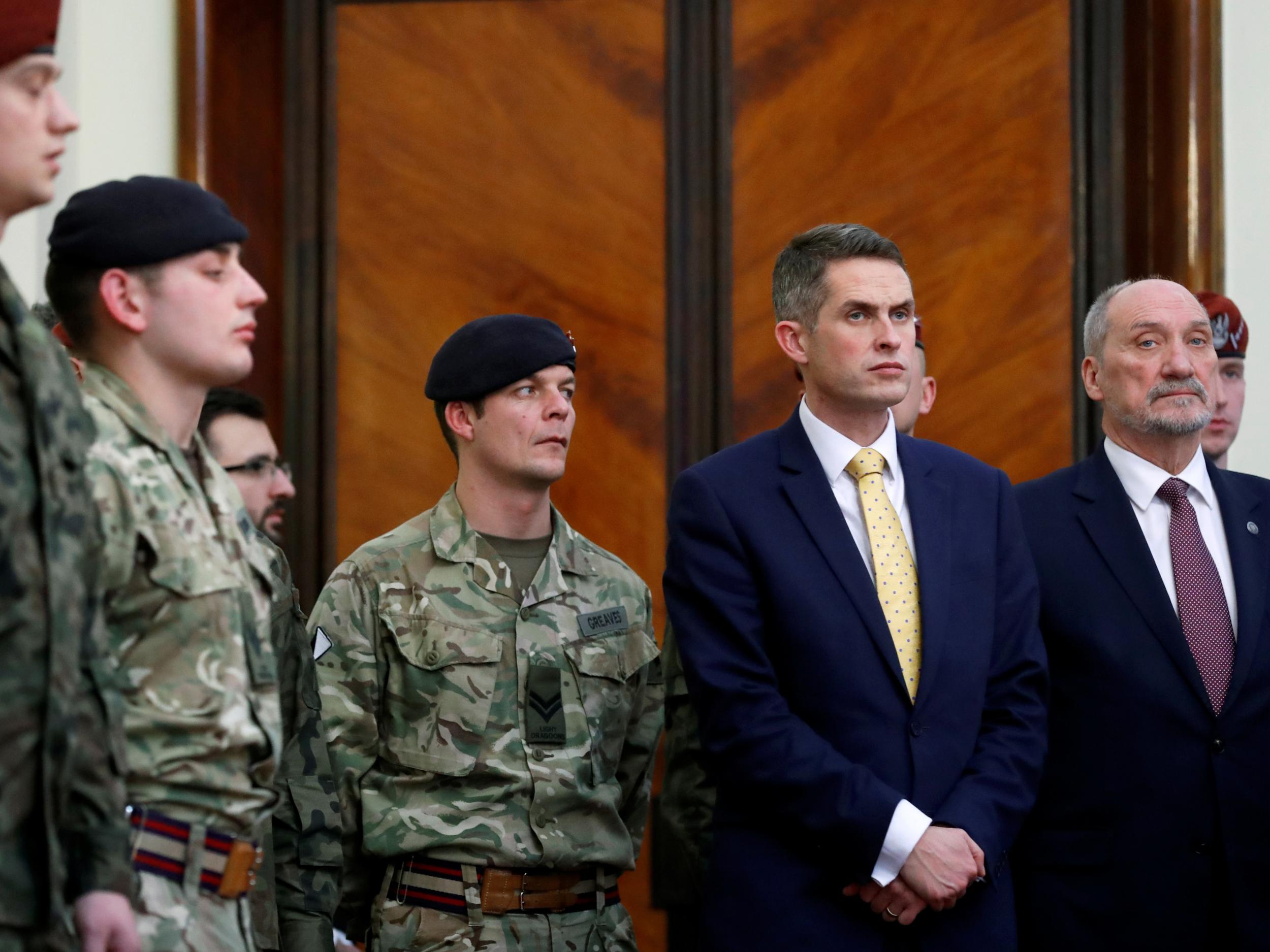 Gavin Williamson and then Polish defence secretary Antoni Macierewicz with soldiers at a meeting of their countries' prime ministers in Warsaw in December 2017