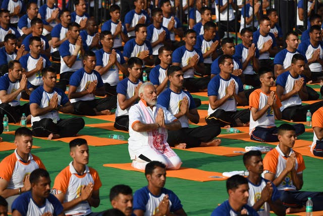 Indian prime minister Narendra Modi participates in a mass yoga session along with 50,000 other practitioners to mark International Day of Yoga in Dehradun