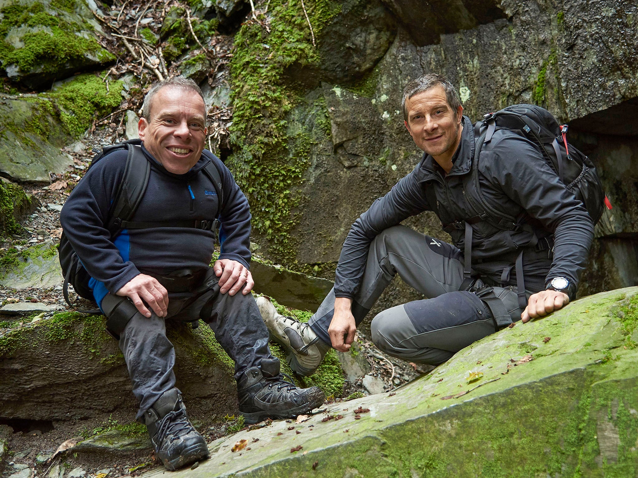 Davis (left) gets put through some gruelling physical challenges by Bear Grylls on the hills of the Lake District