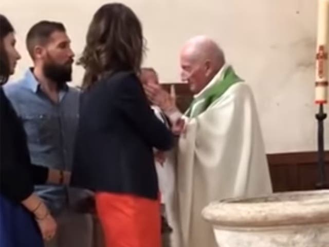 The priest is seen to hit the child in the course of the video