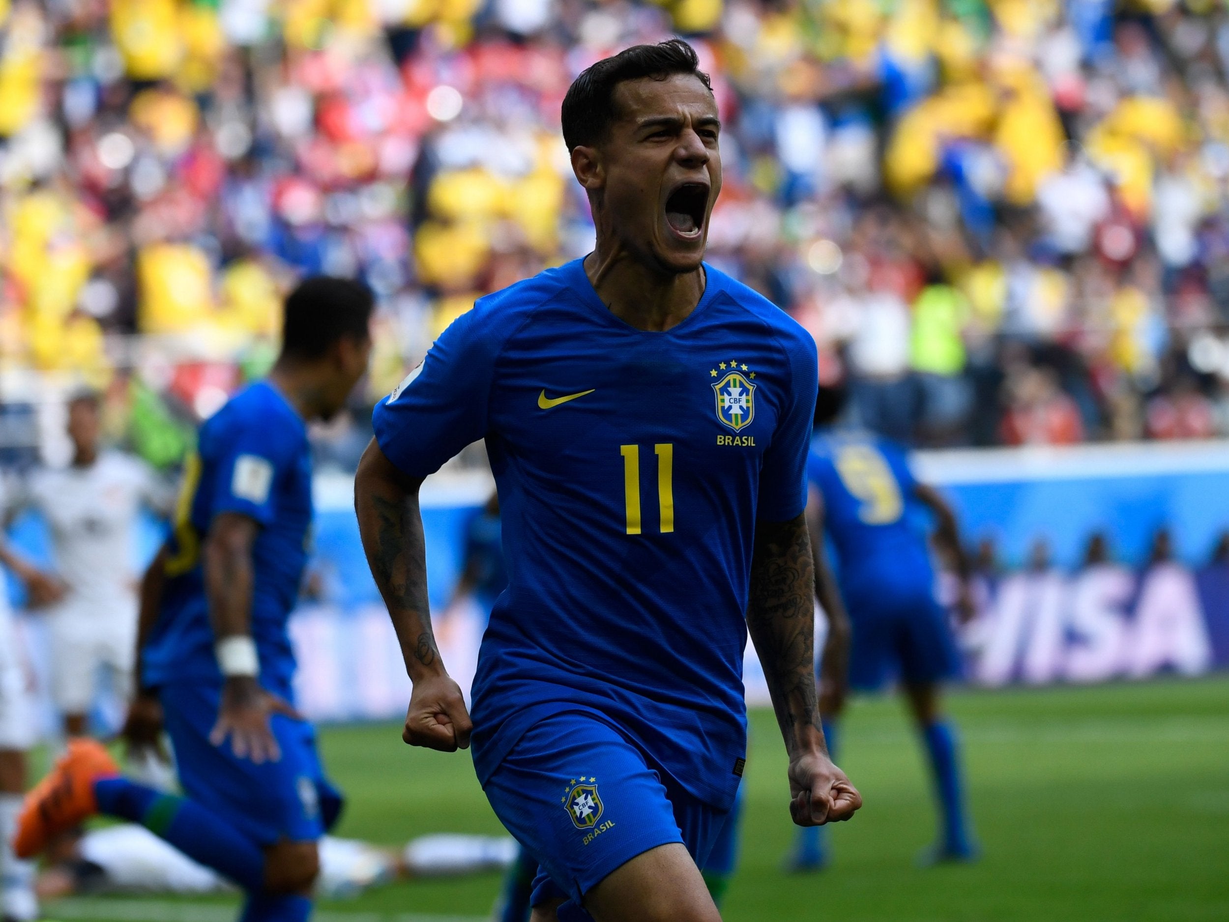 Brazil's forward Philippe Coutinho celebrates scoring the opening goal