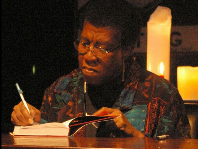 Octavia E Butler signing books for fans