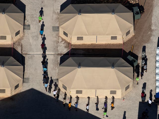 Immigrant children, many of whom have been separated from their parents under a new 'zero tolerance' policy by the Trump administration, are shown walking in single file between tents in their compound next to the Mexican border in Tornillo, Texas