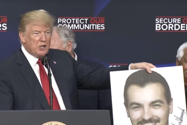 Donald Trump jokes "This is Tom Selleck" while holding a murder victim photo bearing his own signature
