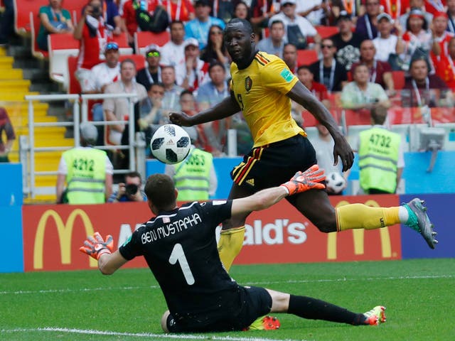 Romelu Lukaku scores Belgium's third goal past Tunisia goalkeeper Farouk Ben Mustapha