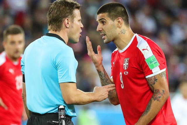 Aleksandar Mitrovic confronts the referee after being brought down in the Switzerland box