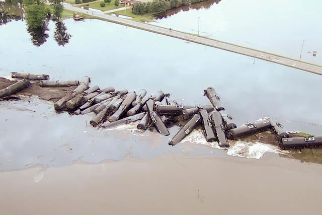Tanker cars carrying crude oil are shown derailed about a mile south of Doon, Iowa