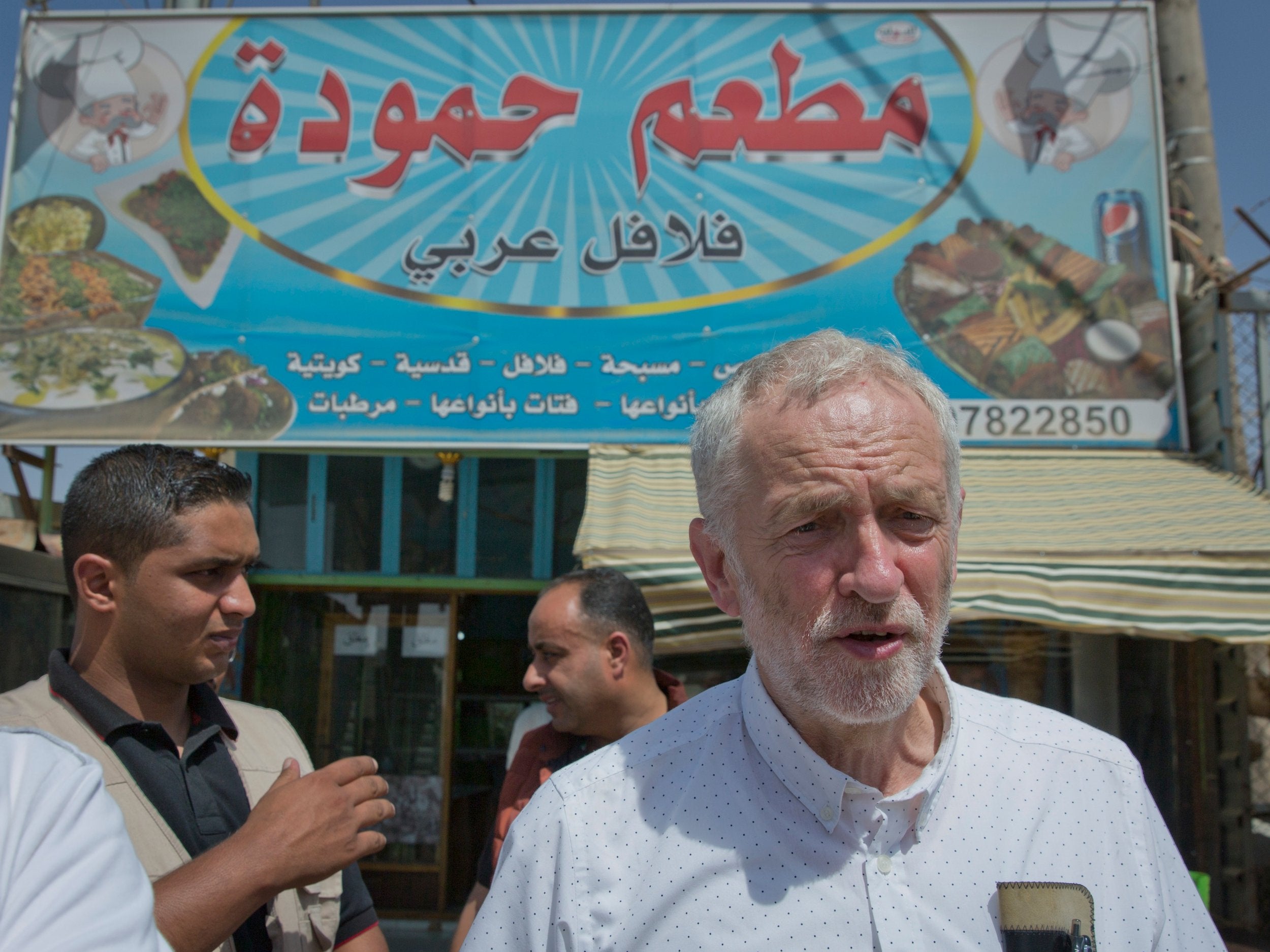  Jeremy Corbyn walks through a market during his visit to the Zaatari Syrian refugee camp in Jordan