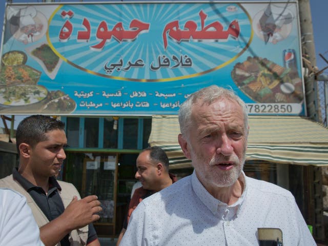 Jeremy Corbyn walks through a market during his visit to the Zaatari Syrian refugee camp in Jordan