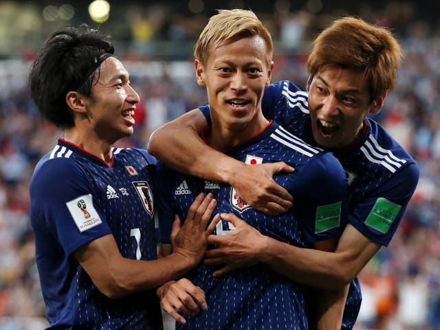 Keisuke Honda of Japan celebrates with teammate Yuya Osako