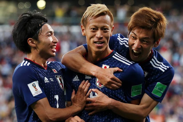 Keisuke Honda of Japan celebrates with teammate Yuya Osako
