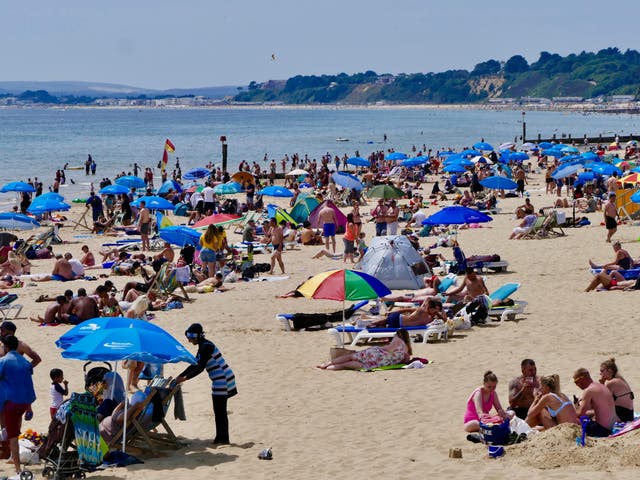 People enjoy a hot afternoon on Bournemouth beach, Dorset, on Sunday