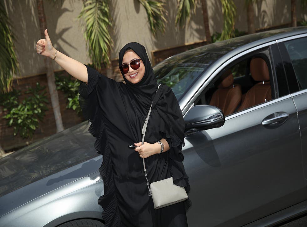 Fadya Fahad, one of the first female taxi drivers in Saudi Arabia, next to her rented car yesterday in the Red Sea city of Jeddah