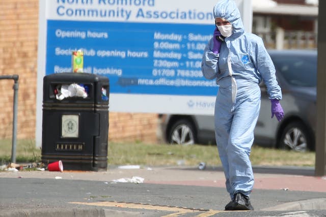 Forensic investigators at the scene of a murder where the victim was stabbed multiple times in London 
