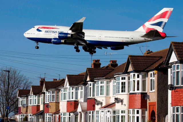 A British Airways 747 passenger jet flies over rooftops as it comes into land at Heathrow