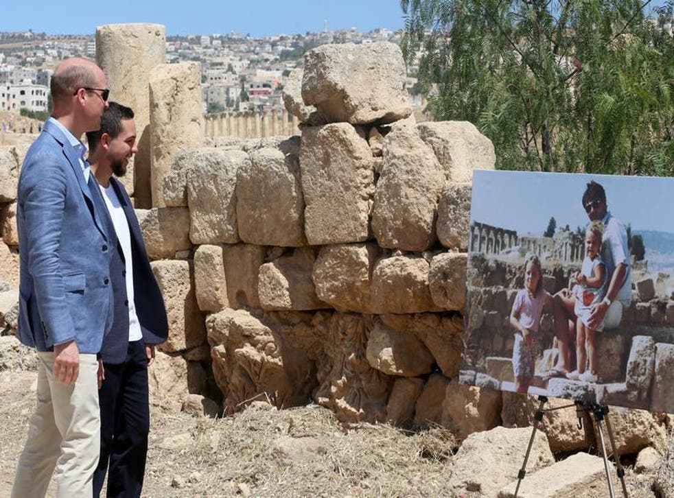 Prince William and Jordan's Crown Prince Hussein look at a photograph showing William's wife, Catherine, the Duchess of Cambridge, as a toddler in Jerash