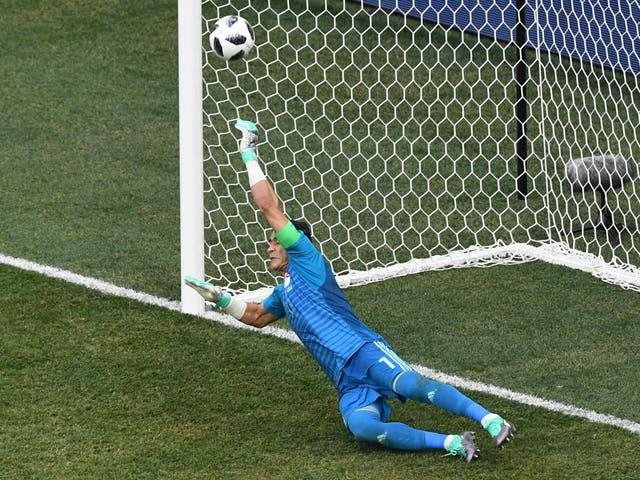 Essam El Hadary dives to save the first penalty awarded against Egypt inside six minutes