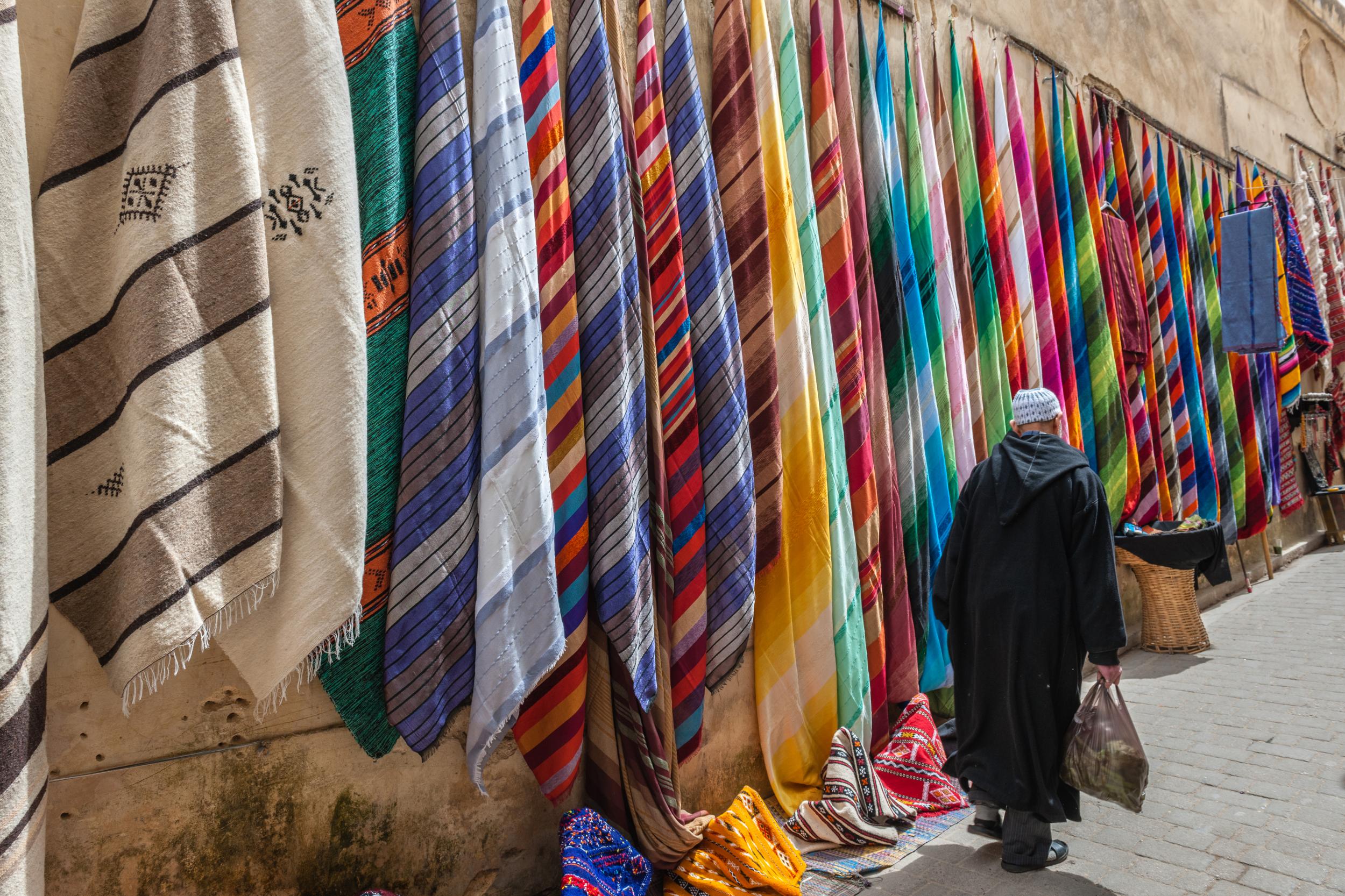 Marvel at the selection of colours and fabrics available in the medina