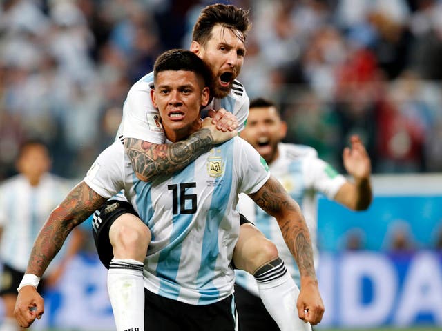 Marcos Rojo and Lionel Messi celebrate Argentina’s late winner
