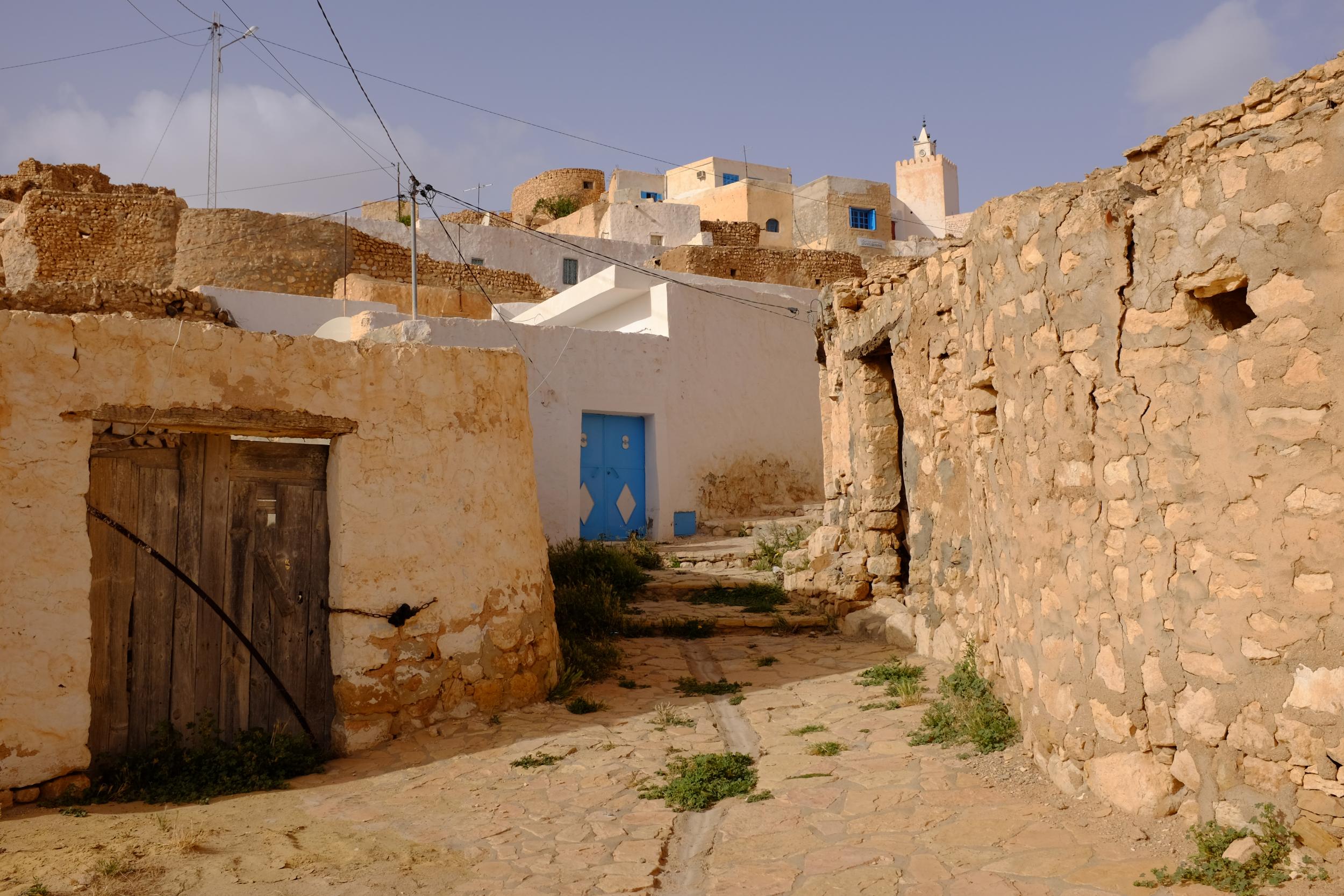 Tamezret blends into the landscape bar a few bright-blue doors