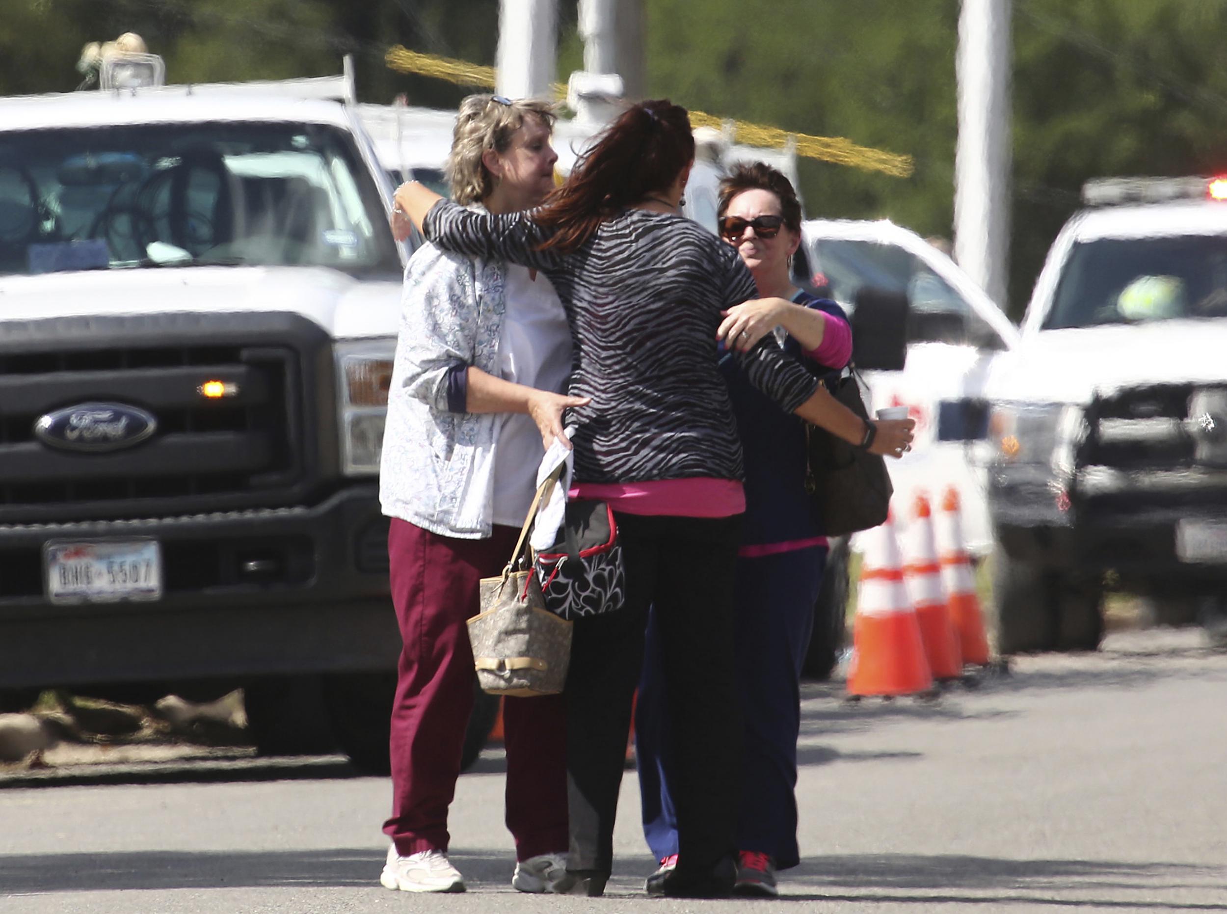 People hug near Coryell Memorial Healthcare System hospital where an explosion in a building under construction injured several people