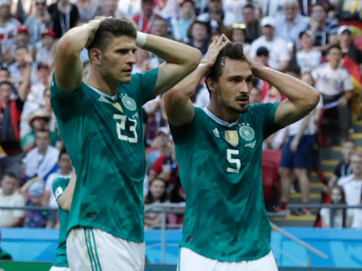 Germany's Mario Gomez, left, and Germany's Mats Hummels, right, hold their heads