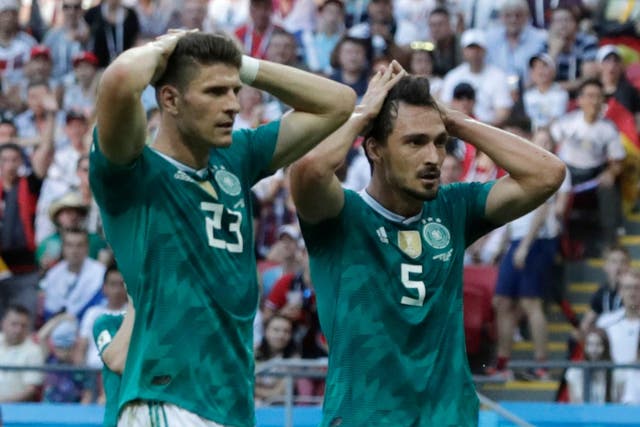 Germany's Mario Gomez, left, and Germany's Mats Hummels, right, hold their heads