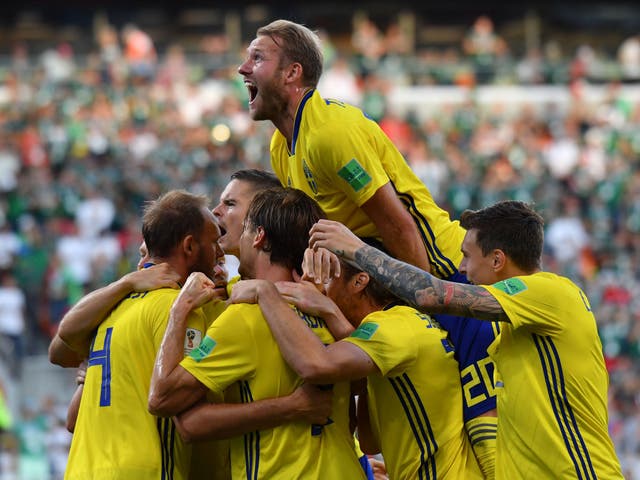Sweden's defender Andreas Granqvist (L) celebrates with teammates