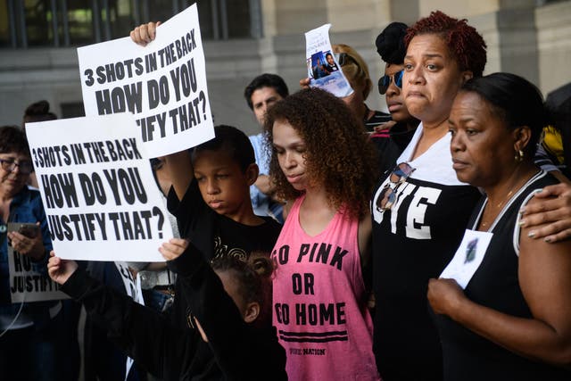 Family members of Antwon Rose II embrace as they listen to speakers during a protest calling for justice for the 17-year-old