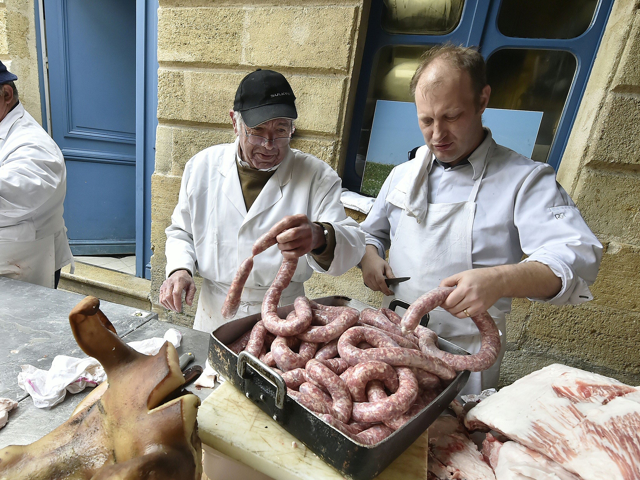 Butchers and cooks prepare pork sausages in the city centre of Bordeaux during the "tue cochon" (pig killing) event, based on an ancestral peasant tradition marking the end of winter