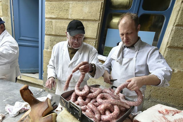 Butchers and cooks prepare pork sausages in the city centre of Bordeaux during the "tue cochon" (pig killing) event, based on an ancestral peasant tradition marking the end of winter
