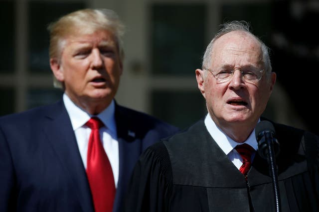 Justice Kennedy speaking alongside Mr Trump at the White House