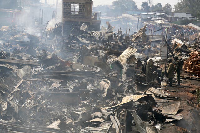 The remains of market stalls still smoulder after a fire swept through the marketplace in Nairobi, Kenya, on Thursday 28 June