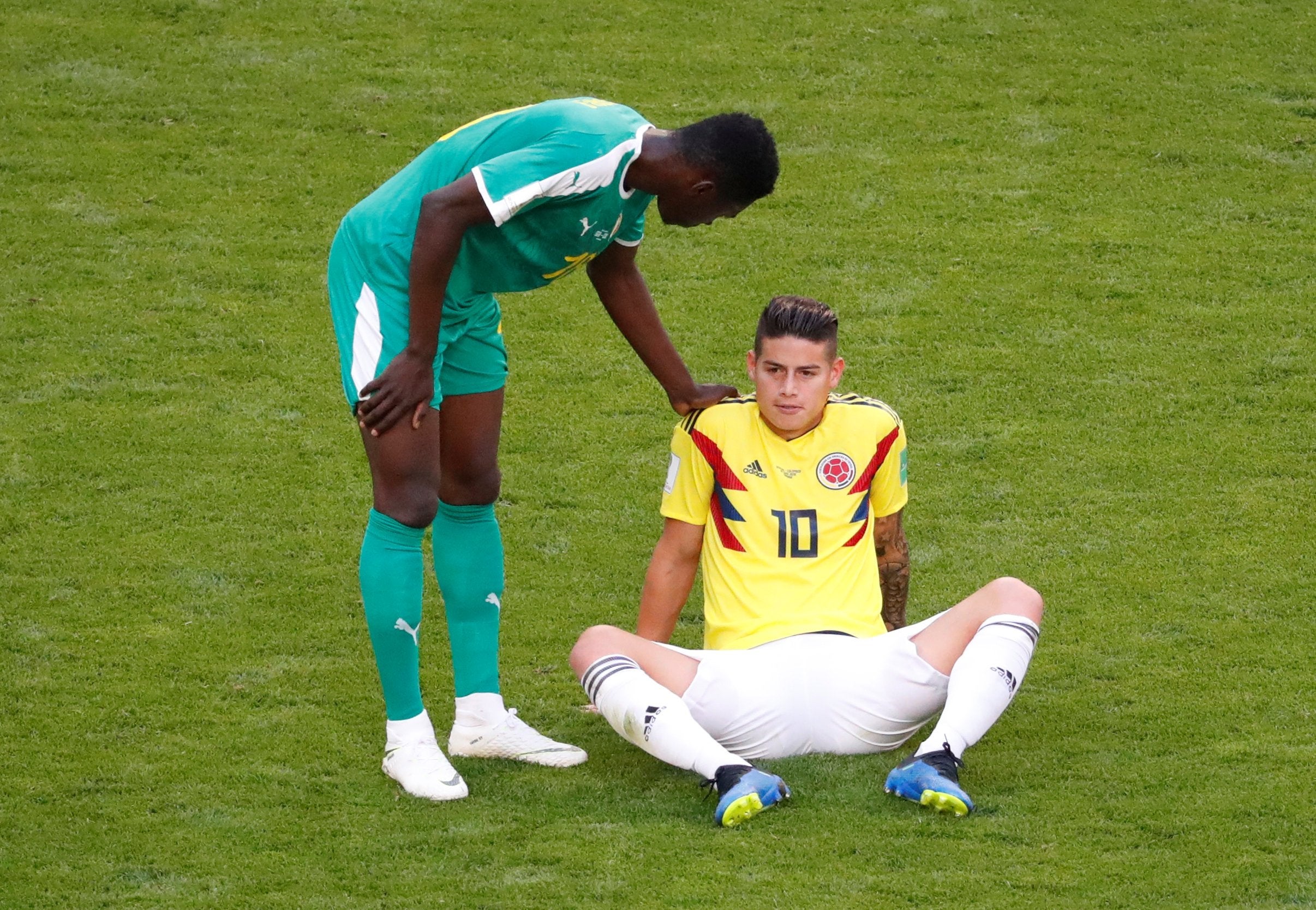 Colombia's James Rodriguez is down before being substituted off