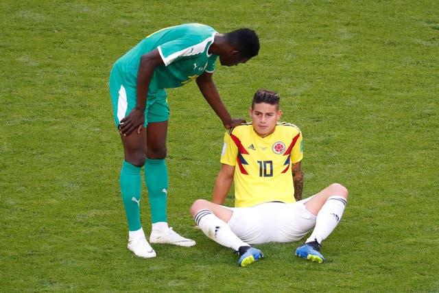 Colombia's James Rodriguez is down before being substituted off