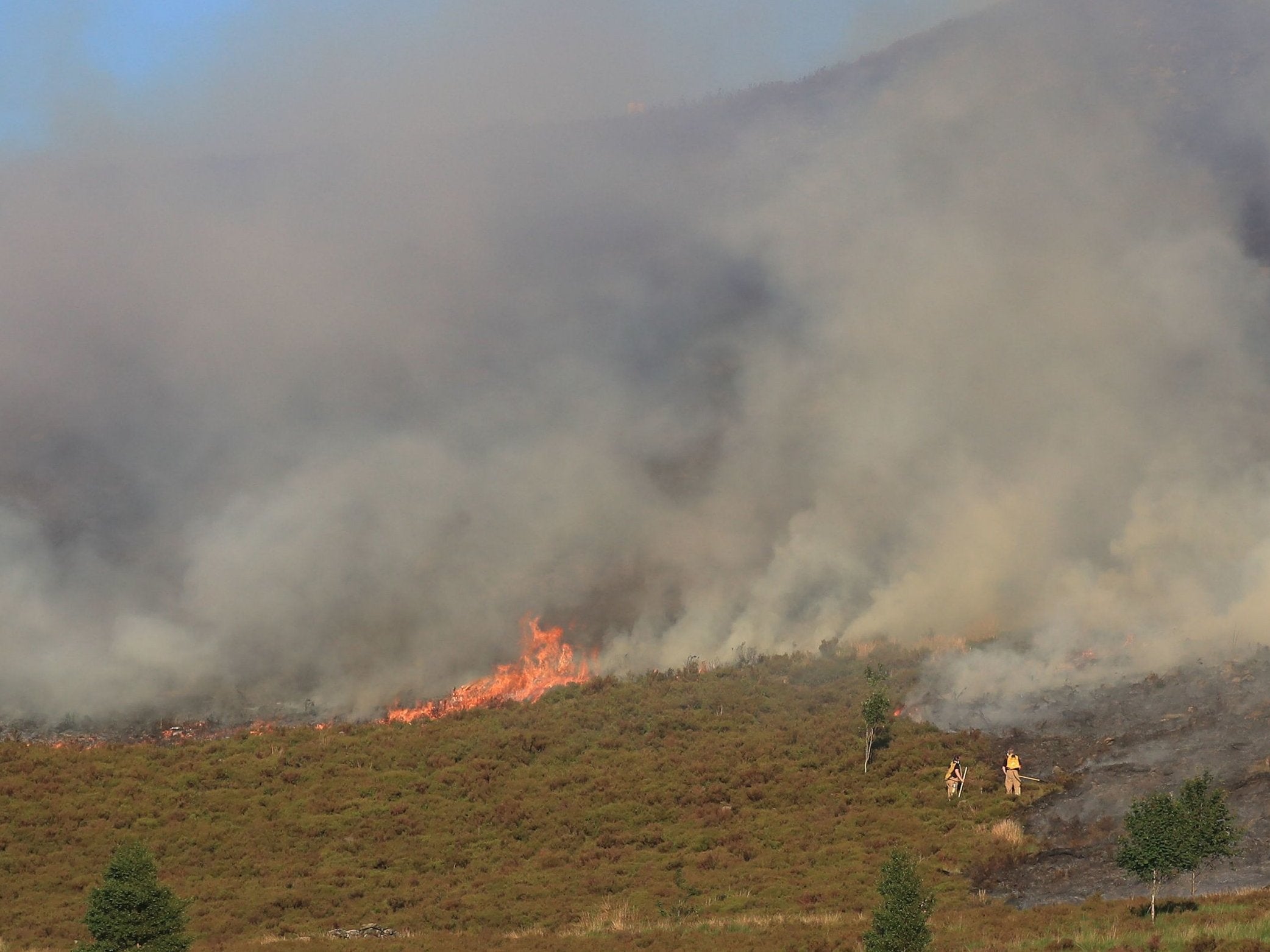 Firefighters tackle the wildfire on Saddleworth Moor, which continues to spread