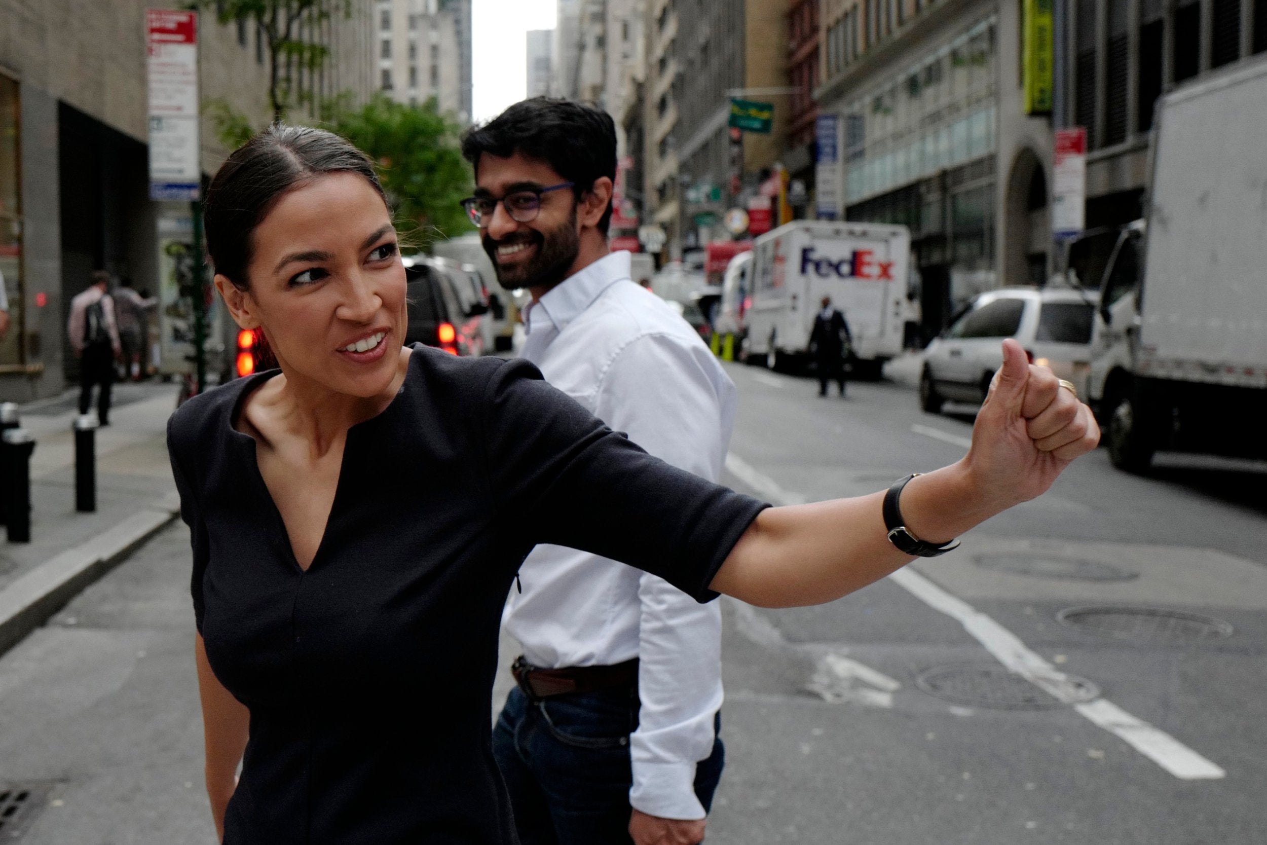 Alexandria Ocasio-Cortez, the winner of a Democratic Congressional primary in New York, reacts to a passerby
