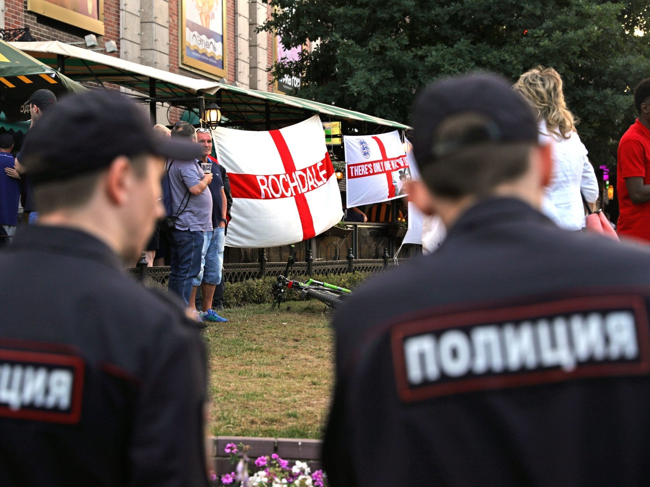Russian police monitor English football fans in a bar in Kaliningrad ahead of their team's match against Belgium