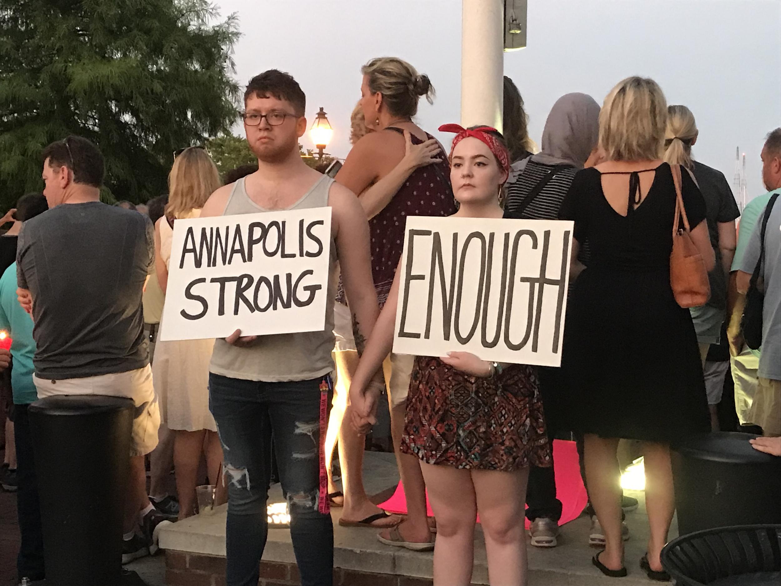 Annapolis residents attend a vigil after a shooting at the offices of the local paper